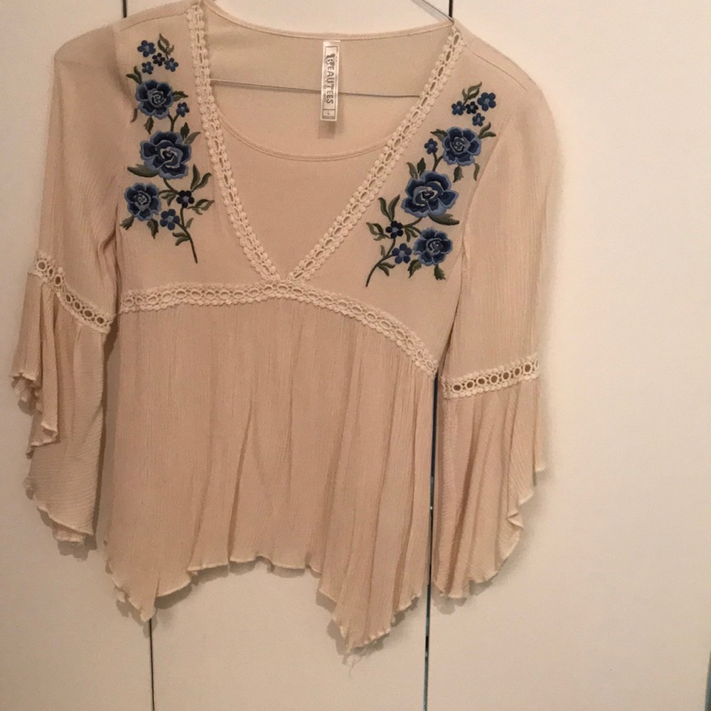 Fancy blouse with lace and floral design.